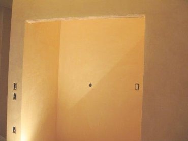 Dramatic yellow plaster in hallway closet in Alexandria, Virginia