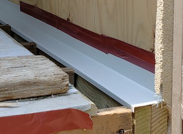 Flashing spans two ledger boards