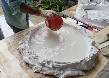 Molding plaster is sifted into a lime ring