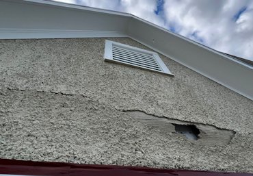 The stucco is falling off the wall in Flint Hill, Virginia