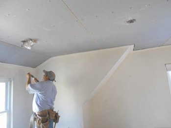 Ceiling is replaced with Imperial plaster base, also known as blue board