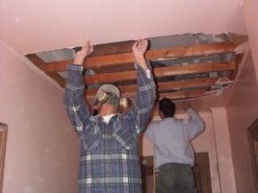 Tearing out
              drywall at Richard's house to restore the plaster