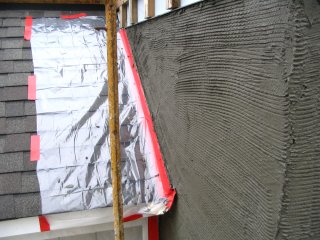 Roof and flashing covered with tape and plastic