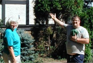 Jim and Lorraine pose with joy in front of their
                new stucco