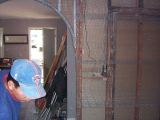 Metal lath is nailed to one wall in the dining room