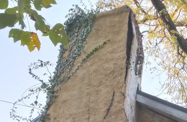 Stucco is popping off this chimney in sheets in Upperville, Virginia.