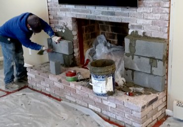 Fireplace surround is built out using blocks