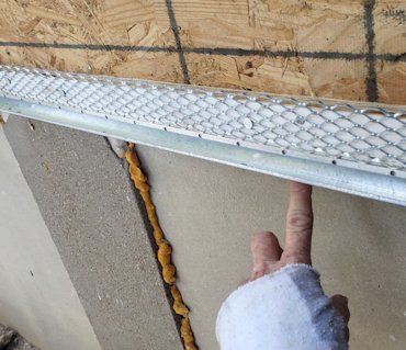 Stop extends below the framing for a good drip edge..