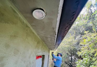 Soffit vents are put in the stucco soffits.