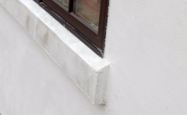 Stucco window sills.