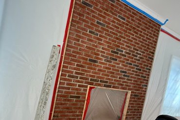 Brick fireplace is plastered