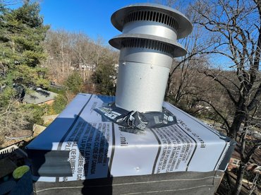 Top of chimney is wrapped with a rubber membrane in Arlington, Virginia