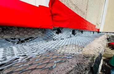 We cut off the stucco to allow the stones to go under the stucco.