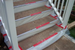 stairs are covered with plastic and masonite