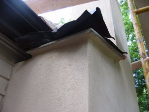 Stucco on a chimney with bad brick