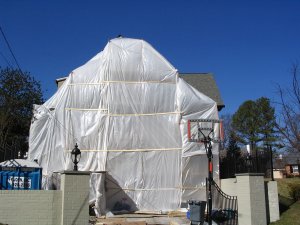 A heat tent
              allows work to proceed in cold weather. We leave the walls
              covered with plastic for about 5 days after we finish.
              Failure to do this can reduce the color retention.
              In other words, we don't take off the plastic until the
              mortar has set up for a few days.