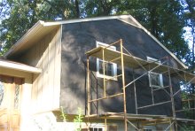 Plywood siding is covered with tar paper and metal
              lath