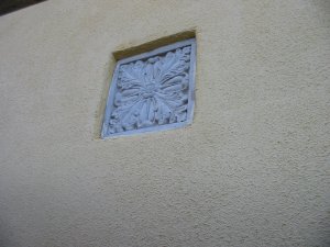 The inset concrete tile shows off  the new  stucco